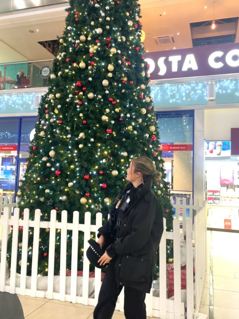 PC Amy Norman standing in front of a Christmas tree