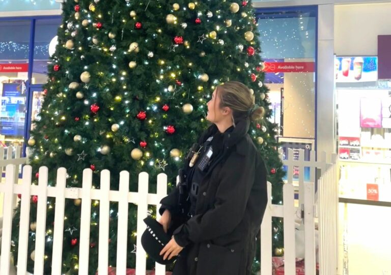 PC Amy Norman standing in front of a Christmas tree