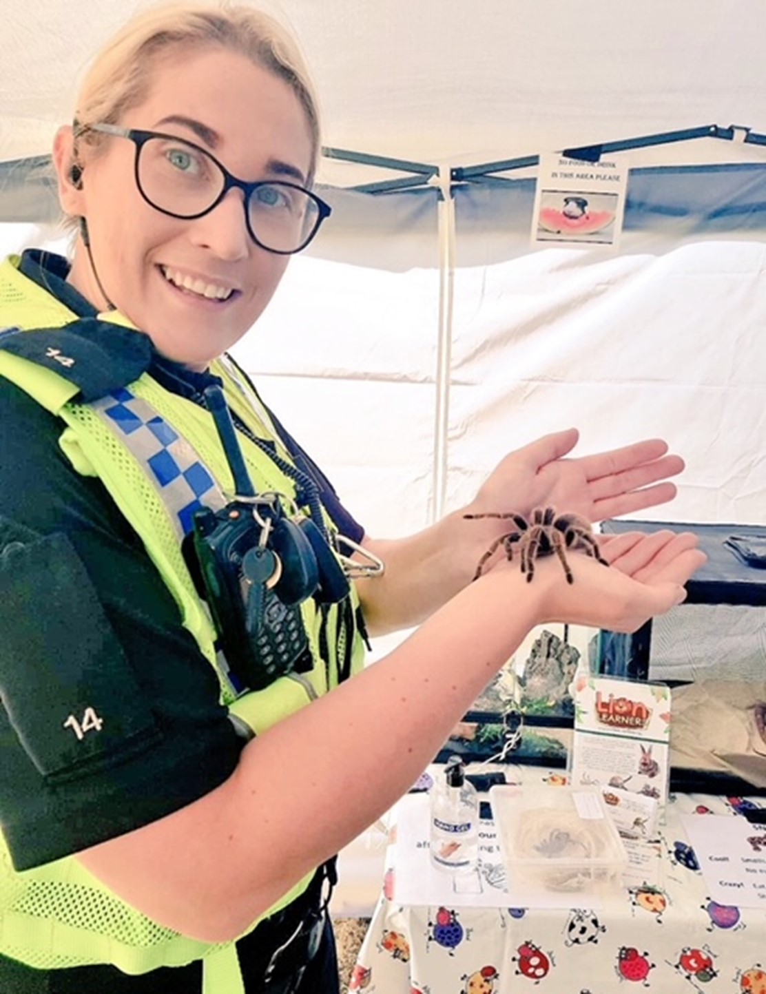 A uniformed officer, Sergeant Nicky Dewhurst, holds a tarantula at the Eastwood Festival - which is organised and run by Clifton Learning Partnership to bring the community together, with input from partners including the police, fire and rescue services, and local authorities