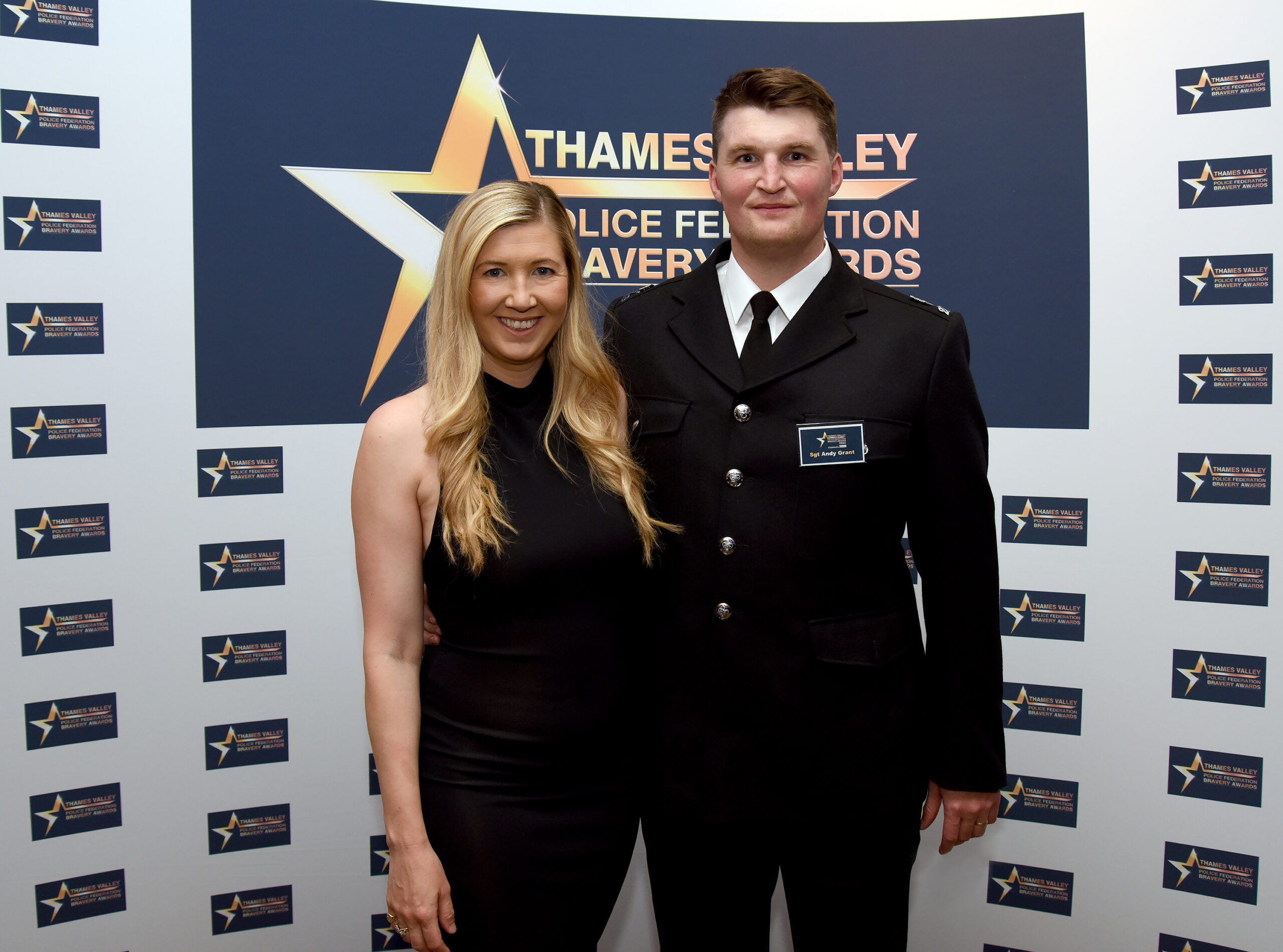Sergeant Andy Grant stands next to a colleague at the Thames Valley Police Federation Bravery Awards 2025