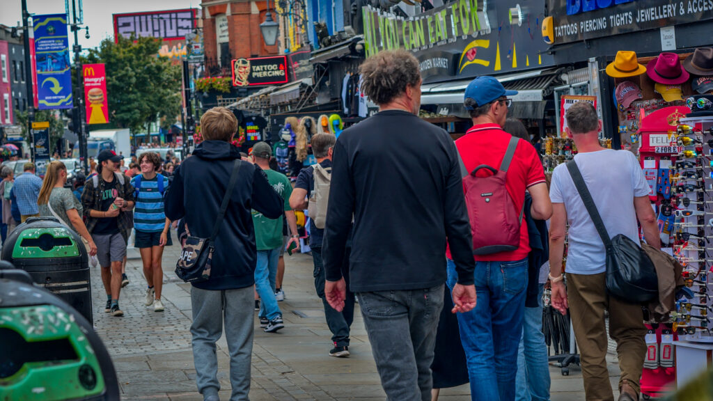 People walking down a colourful and busy street