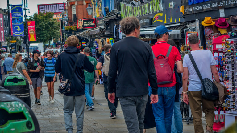 People walking down a colourful and busy street